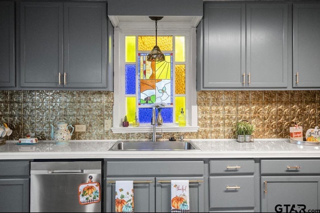 kitchen featuring tasteful backsplash, gray cabinetry, sink, and stainless steel dishwasher