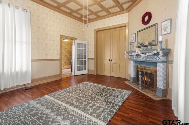 sitting room featuring ornamental molding, dark hardwood / wood-style floors, coffered ceiling, and a tiled fireplace