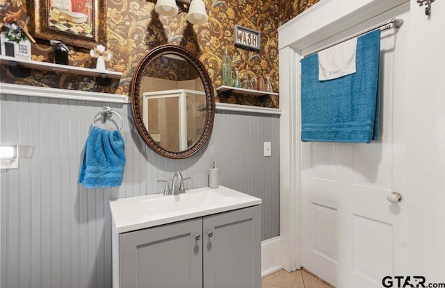 bathroom featuring vanity, tile patterned floors, and a shower with door