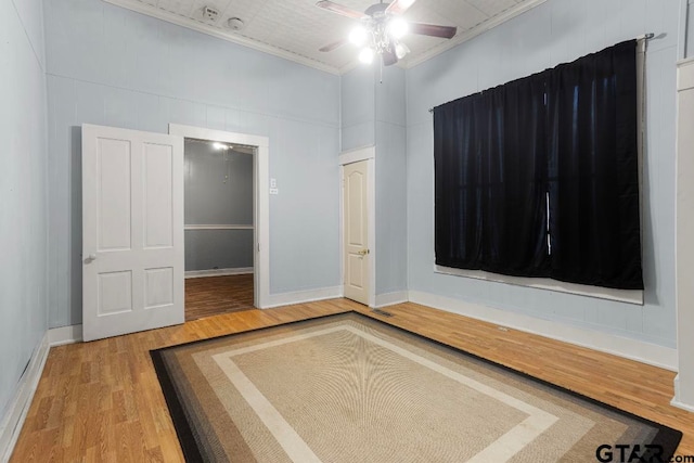 unfurnished bedroom with crown molding, ceiling fan, and wood-type flooring