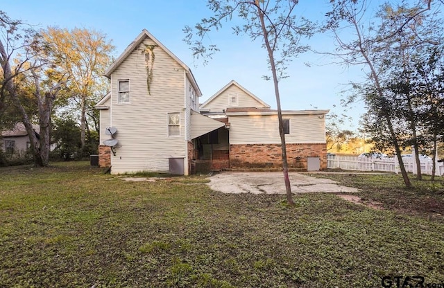 rear view of property with a yard