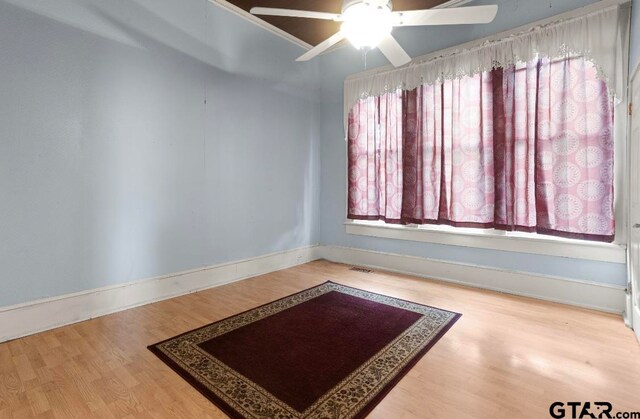 unfurnished room with ceiling fan and hardwood / wood-style flooring