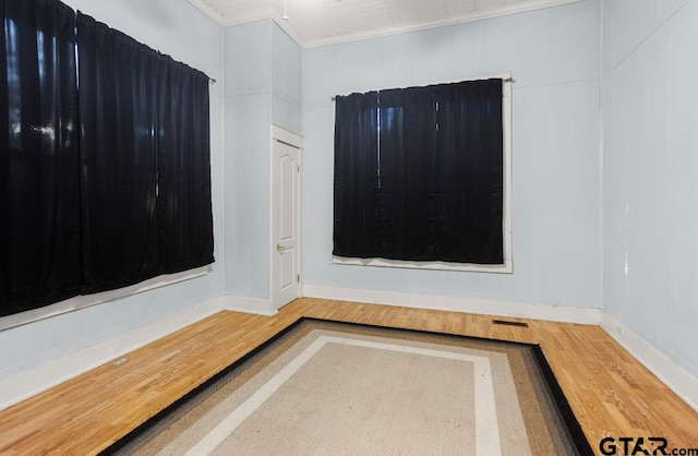 details with hardwood / wood-style flooring and crown molding