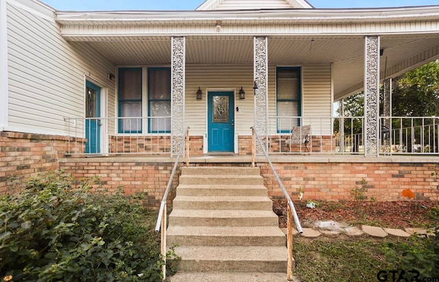 view of exterior entry featuring a porch