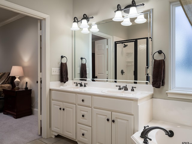 full bathroom featuring a sink, a bath, a stall shower, and double vanity