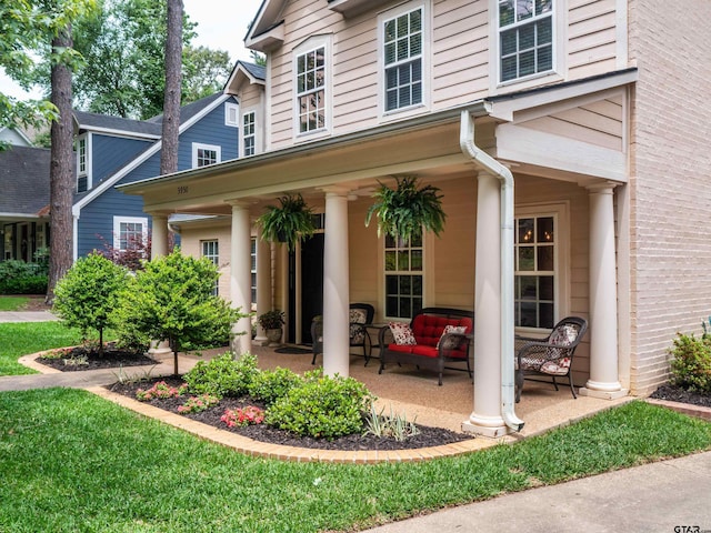 property entrance featuring a patio and an outdoor living space
