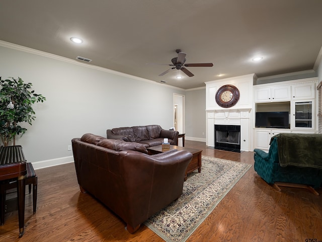 living area featuring baseboards, crown molding, ceiling fan, and visible vents