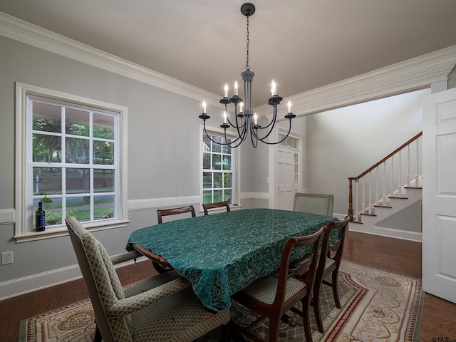 dining space with a notable chandelier, ornamental molding, wood finished floors, and stairway