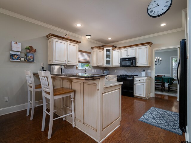 kitchen with tasteful backsplash, a breakfast bar area, black appliances, and a peninsula