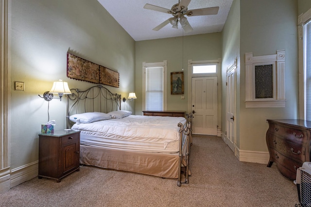 carpeted bedroom featuring a textured ceiling and ceiling fan