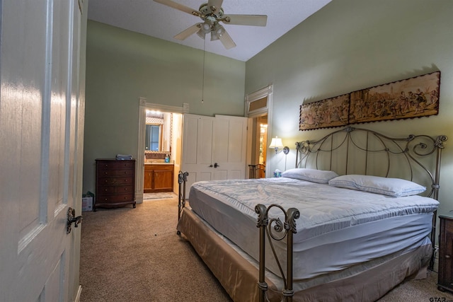 carpeted bedroom with ceiling fan and connected bathroom