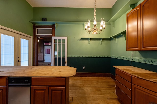 kitchen with french doors, butcher block counters, a chandelier, hardwood / wood-style flooring, and decorative light fixtures