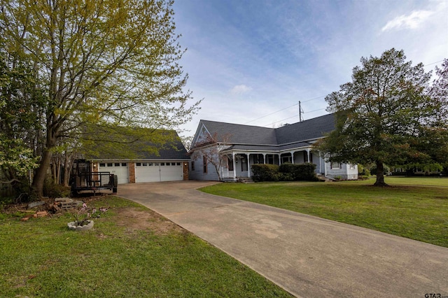 view of front of property with a garage, a front lawn, and covered porch