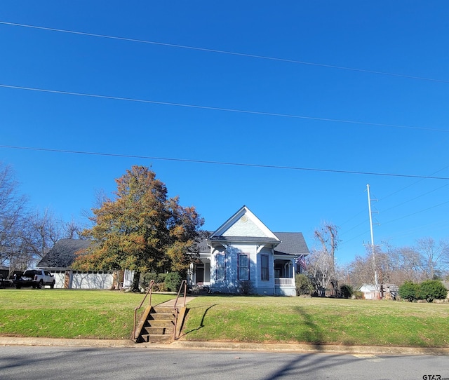 view of front of home with a front yard and covered porch