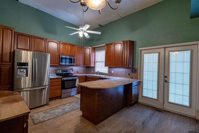 kitchen with plenty of natural light, light wood-type flooring, and stainless steel appliances