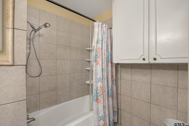 bathroom featuring shower / tub combo with curtain and a textured ceiling