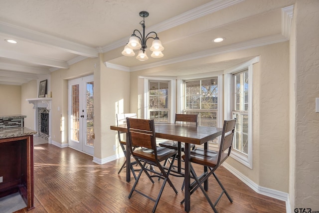 dining space featuring beam ceiling, dark wood-type flooring, ornamental molding, and a chandelier