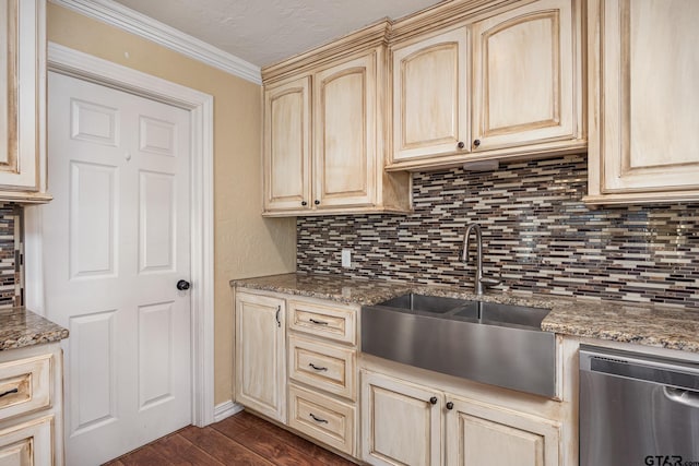 kitchen featuring sink, dishwasher, ornamental molding, light brown cabinetry, and dark stone counters