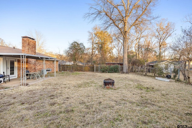 view of yard with an outdoor fire pit