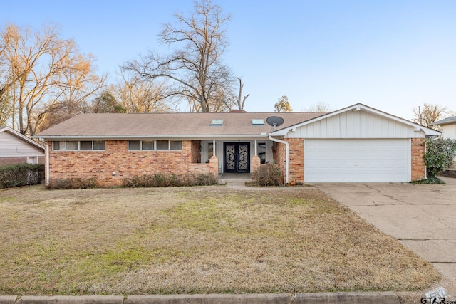 ranch-style home featuring a garage, a front yard, and french doors