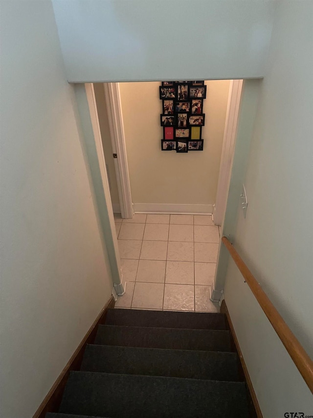 stairway with tile patterned flooring