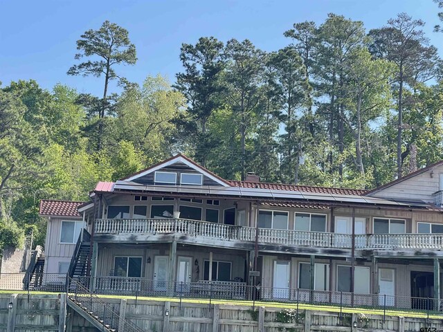 464 Forest Hills Dr, Livingston, TX 77351 - view of front of house with stairway and board and batten siding
