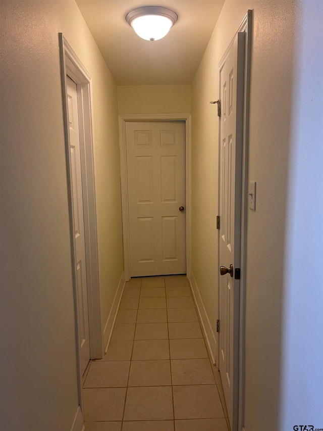 corridor with light tile patterned floors