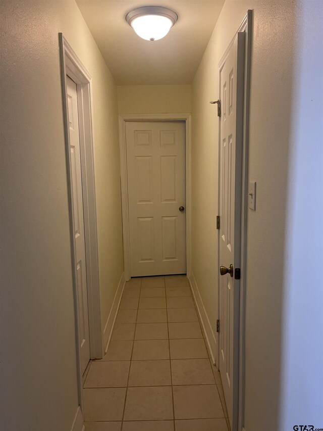 464 Forest Hills Dr, Livingston, TX 77351 - hallway with light tile patterned flooring and baseboards