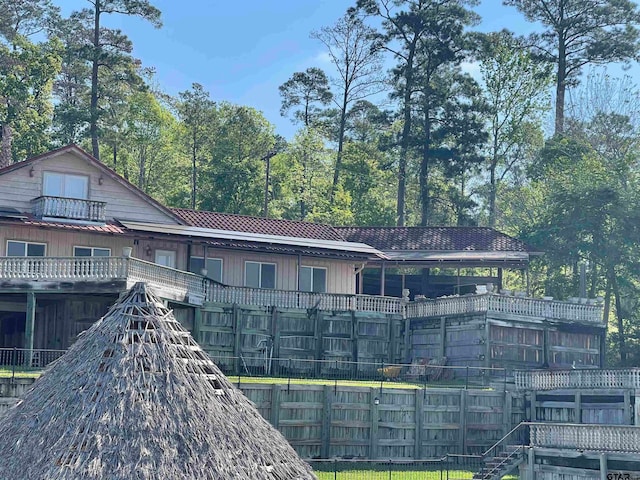 back of house featuring a balcony