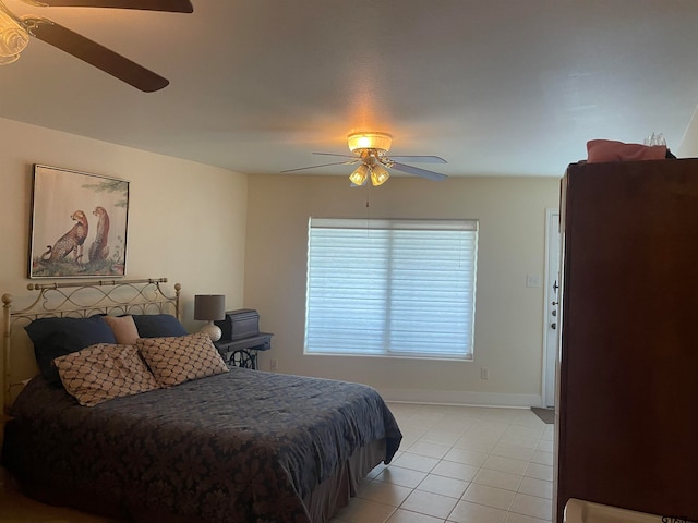 bedroom with ceiling fan and light tile patterned floors