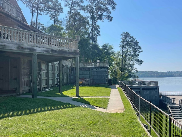 view of community featuring a water view and a yard