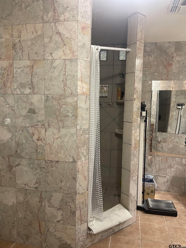 bathroom with tile patterned floors and tile walls