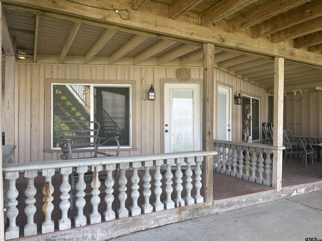 464 Forest Hills Dr, Livingston, TX 77351 - doorway to property featuring board and batten siding and a porch