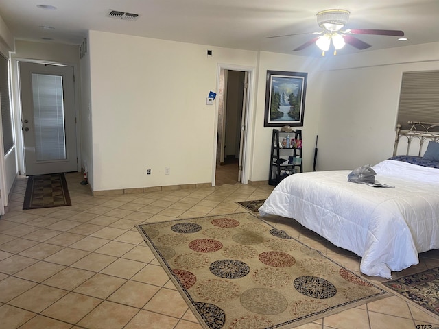 tiled bedroom with ceiling fan