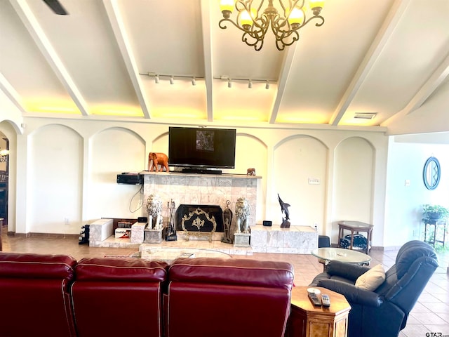 tiled living room with a fireplace, a chandelier, and track lighting