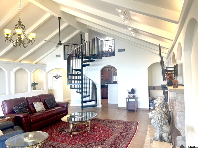 464 Forest Hills Dr, Livingston, TX 77351 - living room featuring arched walkways, stairs, tile patterned flooring, high vaulted ceiling, and baseboards