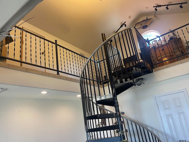 stairway with lofted ceiling