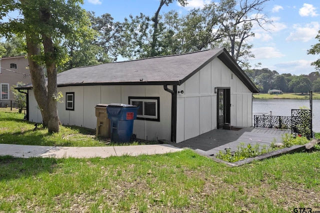 exterior space with a deck with water view and a yard