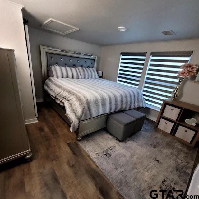 bedroom featuring dark wood-type flooring