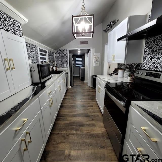 kitchen featuring stainless steel range with electric cooktop, wall chimney range hood, dark hardwood / wood-style flooring, hanging light fixtures, and white cabinets