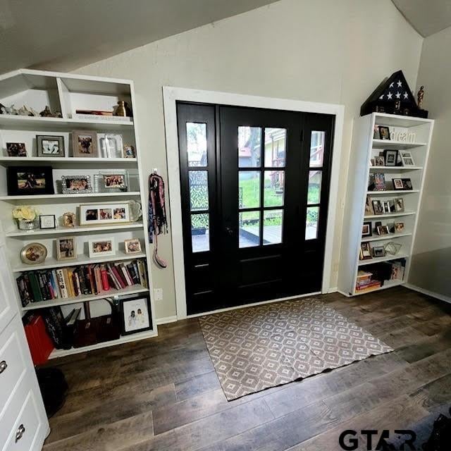 foyer featuring vaulted ceiling and dark hardwood / wood-style flooring