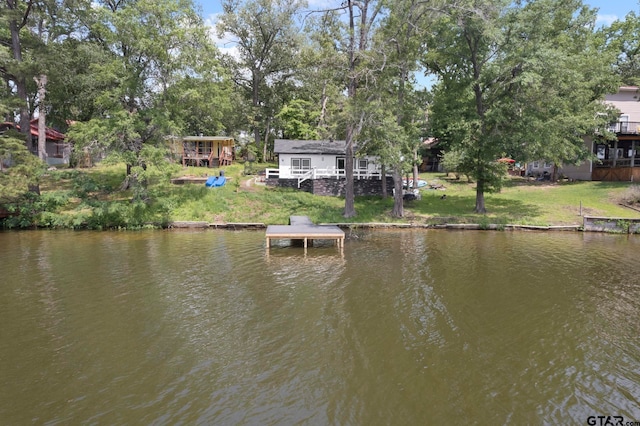 view of dock featuring a yard and a water view