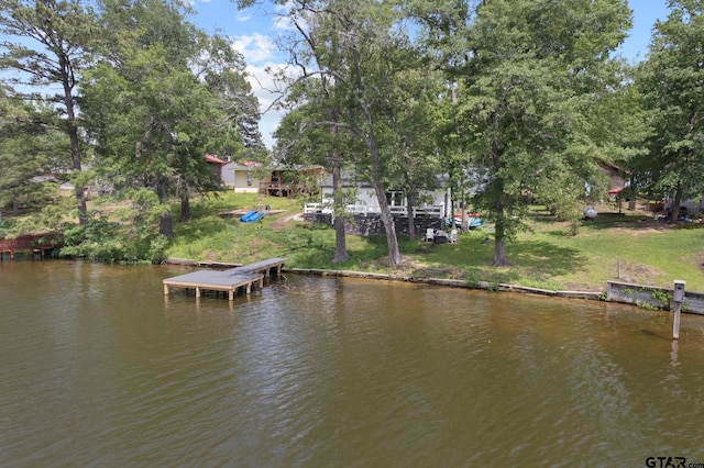 dock area with a lawn and a water view