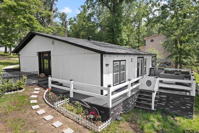 back of house featuring a wooden deck and ac unit