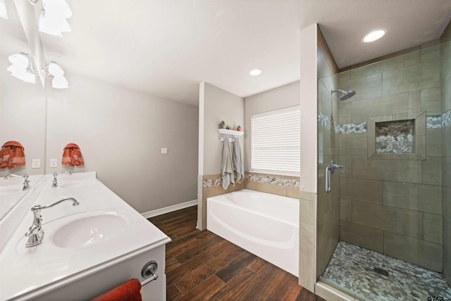 bathroom featuring wood-type flooring, vanity, and separate shower and tub