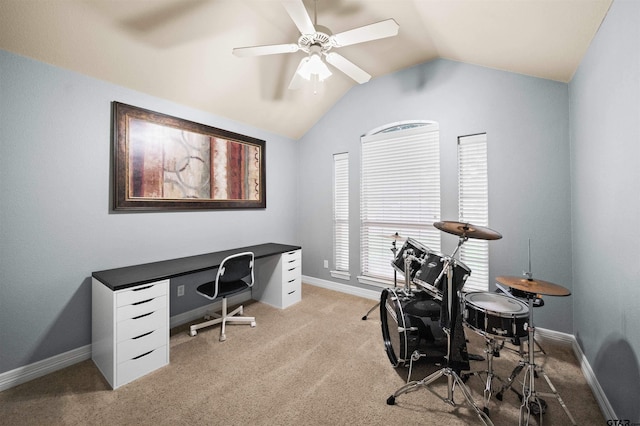 carpeted office space with ceiling fan and vaulted ceiling