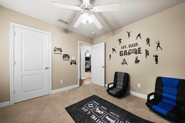 sitting room with ceiling fan and carpet floors