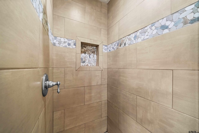 bathroom with tiled shower