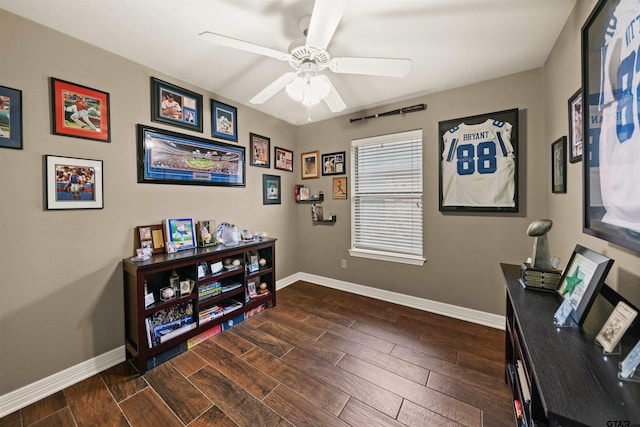 home office with dark wood-type flooring and ceiling fan