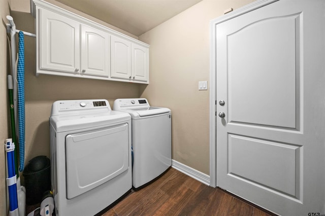 laundry room featuring cabinets, washer and clothes dryer, and dark hardwood / wood-style flooring